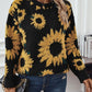 Bohemian-inspired black sweater with textured sunflower designs.
