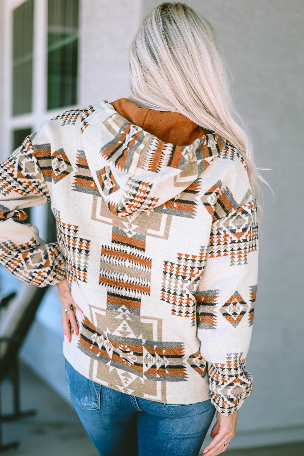 Close-up of aztec print and suede pocket detail on hoodie
