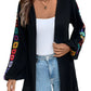 Boho embroidered open-front cardigan in black with colorful floral sleeves.
