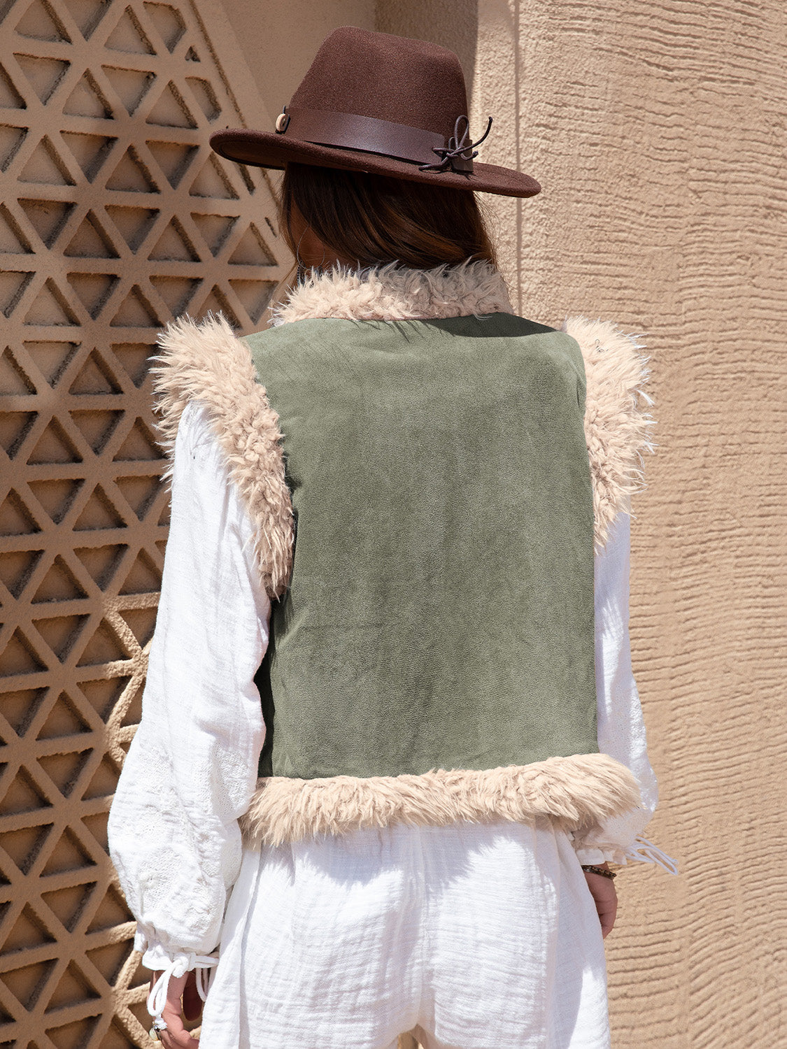 Western-style vest with faux shearling trim and embroidered accents.
