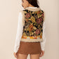 Women’s boho-inspired vest with floral embroidery and faux shearling trim.
