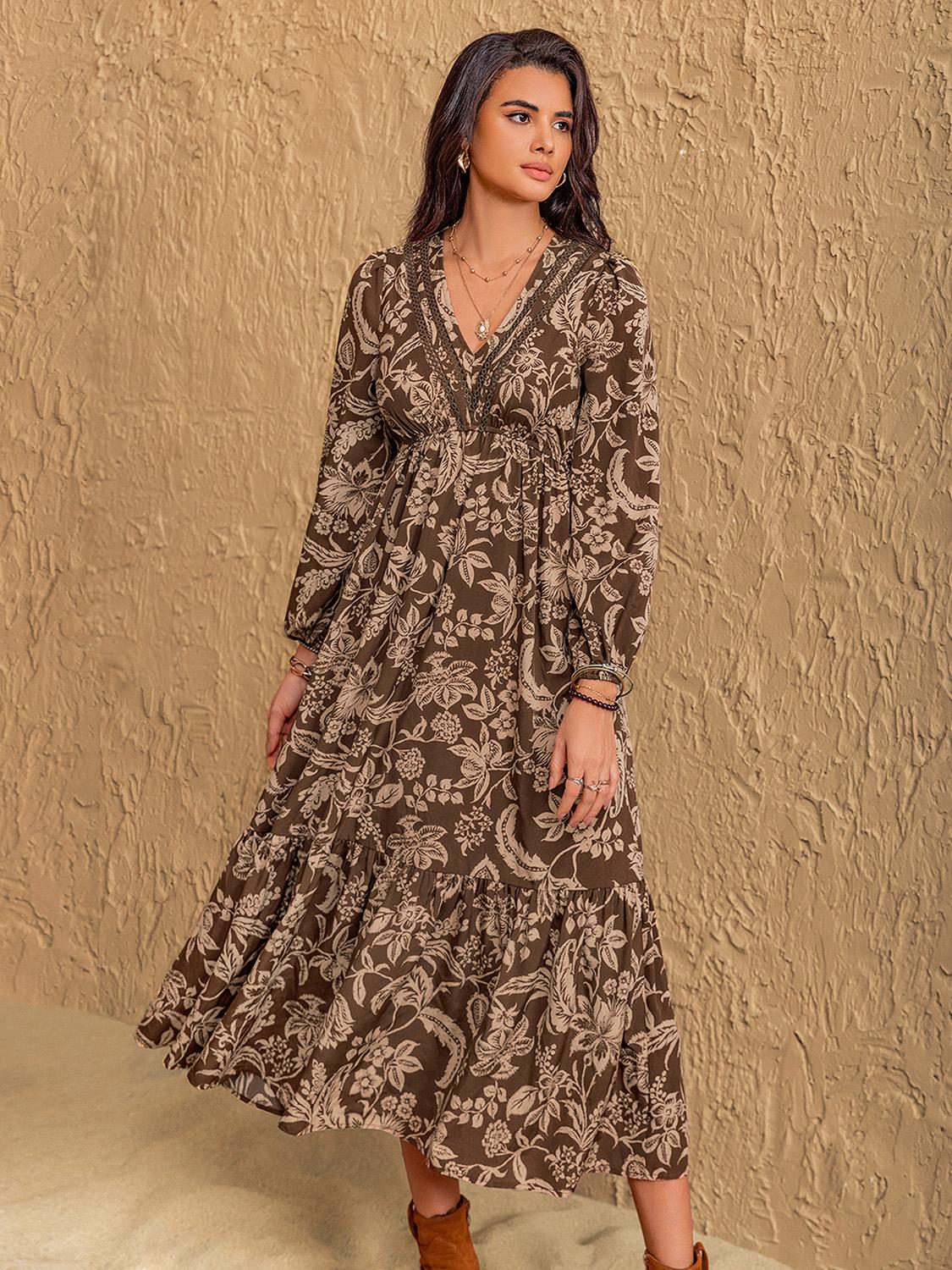 Woman wearing tiered skirt long sleeve midi dress in earthy tones.
