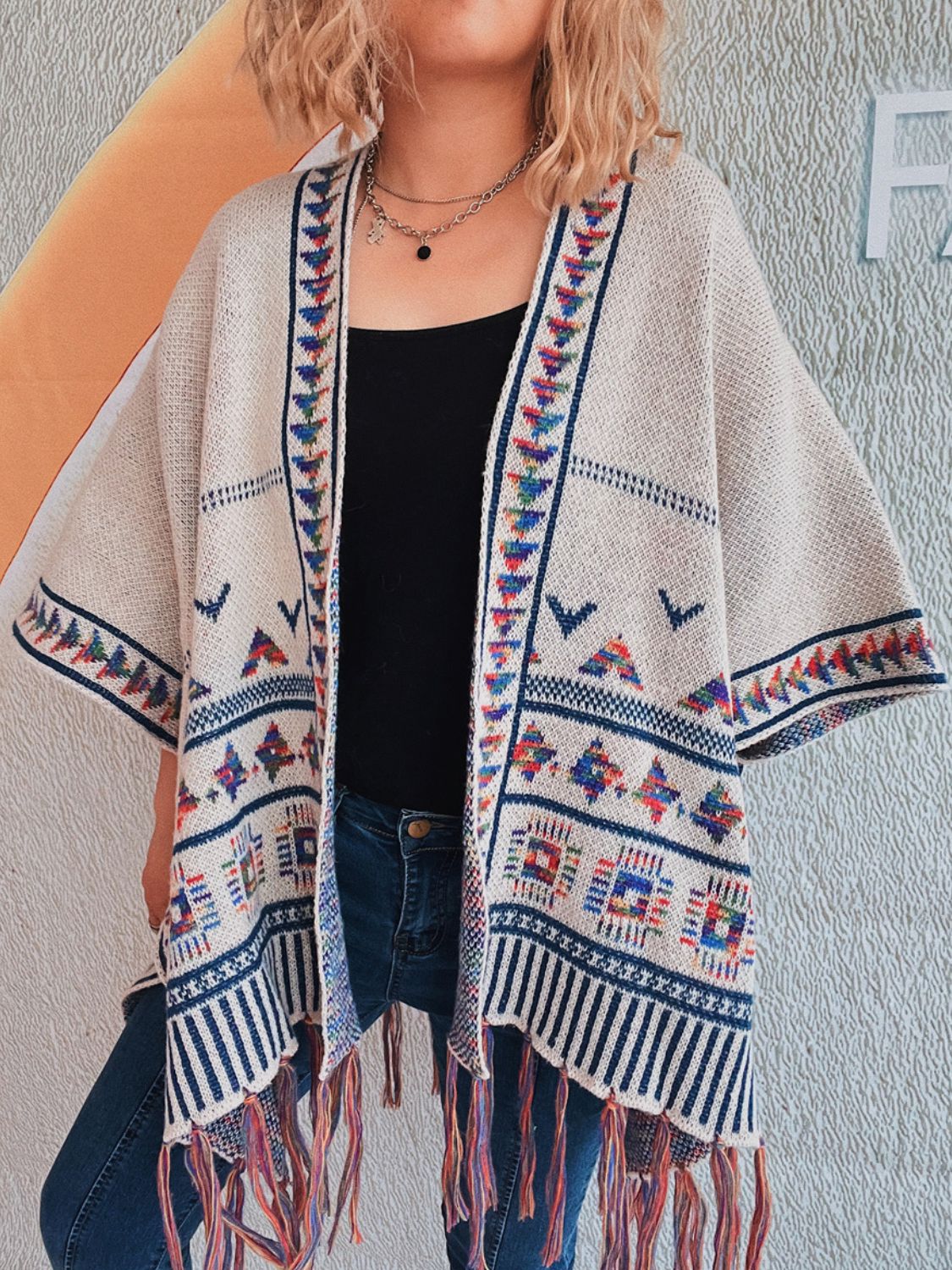 Open-front fringe cardigan featuring tribal-inspired patterns
