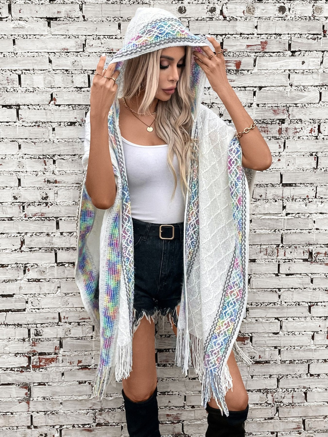 Cozy white poncho with hood, styled for a chic, casual look
