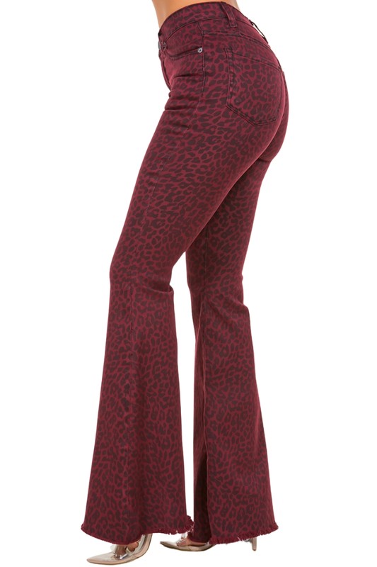 Statement burgundy flared jeans with a fierce leopard print pattern.