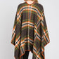 Woman styled in green plaid wrap shawl with relaxed open fit.
