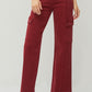 Relaxed fit high-rise wide leg jeans in red, styled casually with heels.
