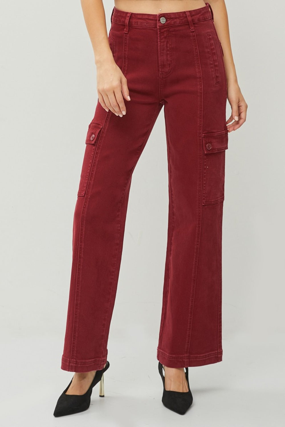 Relaxed fit high-rise wide leg jeans in red, styled casually with heels.
