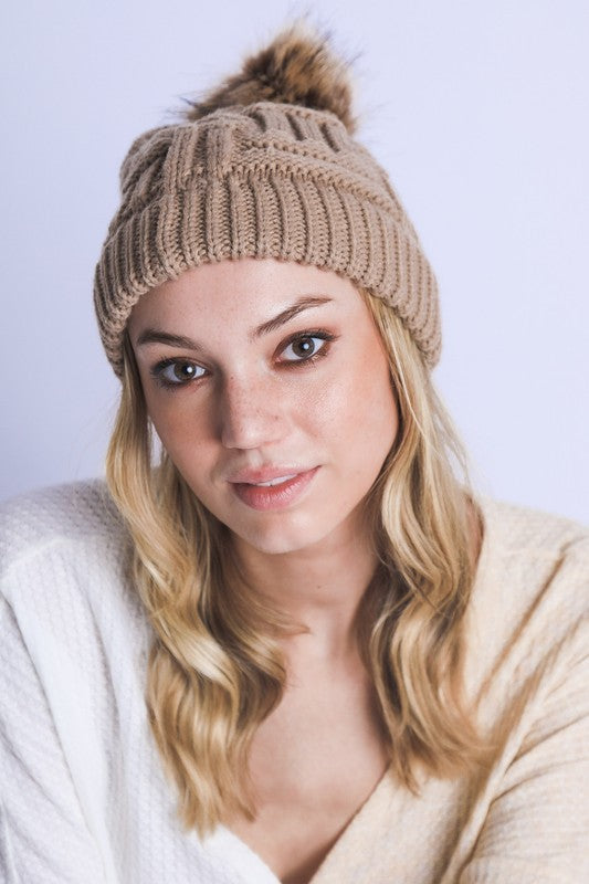 Classic tan cable knit beanie with braided pattern and faux fur pom

