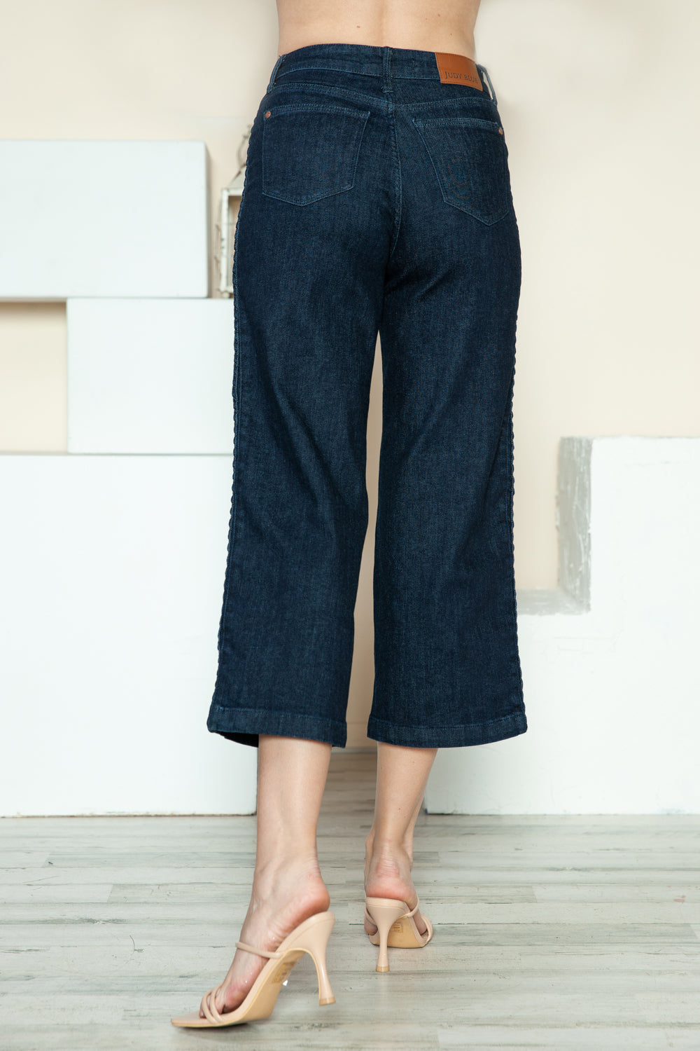 Side view of braided seam detail on cropped Judy Blue wide-leg jeans.
