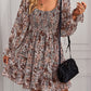 Brown bohemian dress with floral print, long sleeves, and an elegant ruffle detail.
