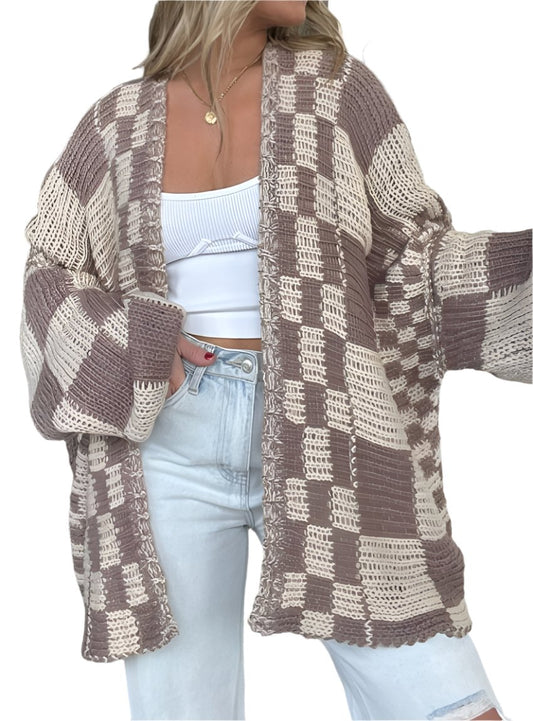 Woman wearing an oversized brown checkerboard knit cardigan
