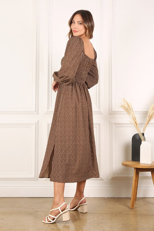 Women's smocked midi dress featuring long puff sleeves and a flattering fit.
