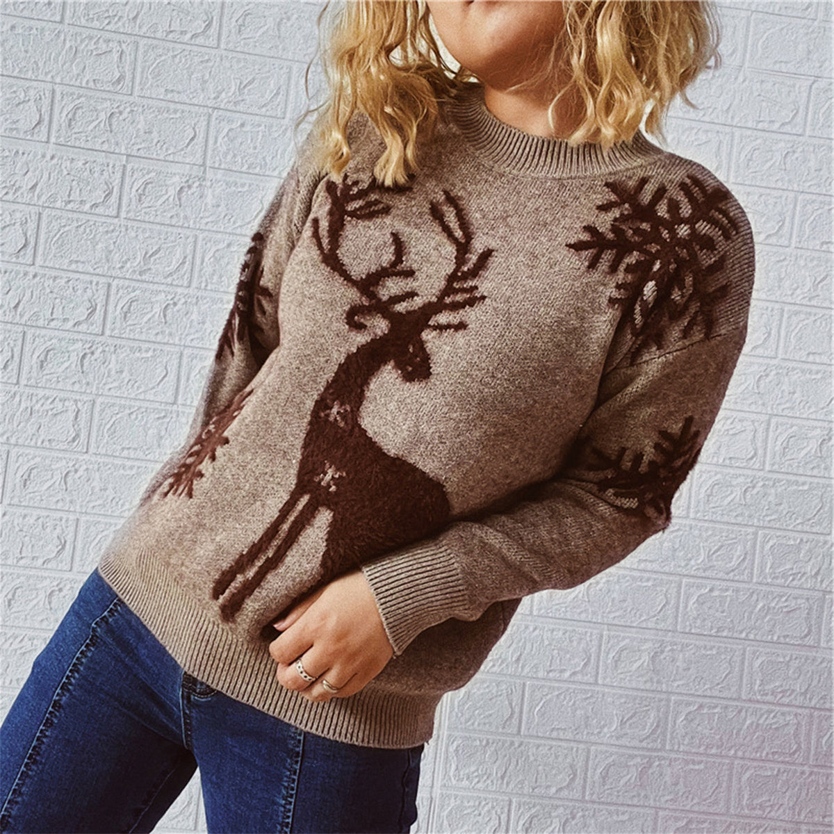 Detailed knit pattern of the brown reindeer sweater, featuring a festive reindeer and snowflake design.

