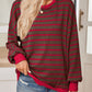 Brown pullover with red stripes, adding a retro-inspired touch.
