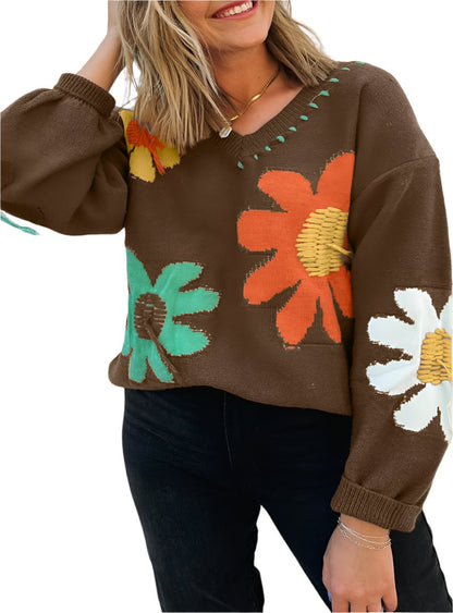 Woman wearing a brown floral sweater with retro flower patterns and lantern sleeves.
