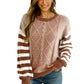 Front view of a brown striped round neck sweater with dropped shoulders.
