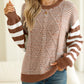 Brown striped sweater with dropped shoulders, perfect for layering in fall.
