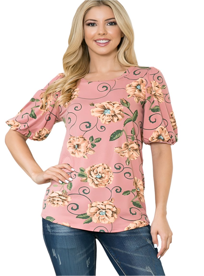 Woman wearing a bubble sleeve top with a pink floral print
