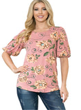 Woman wearing a bubble sleeve top with a pink floral print
