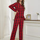 Women’s buffalo plaid pajama set displayed by a Christmas tree.
