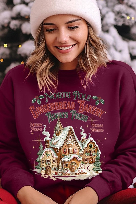 Festive burgundy sweatshirt with gingerbread house graphic, perfect for the holidays.