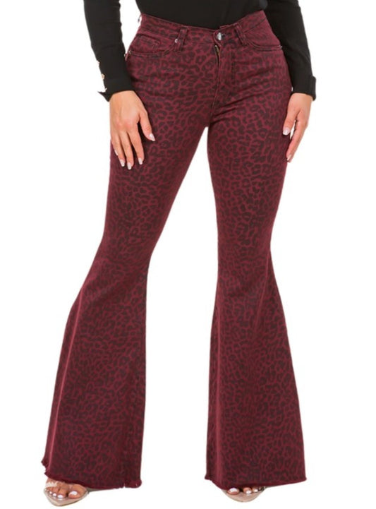 Woman wearing high-rise burgundy flared jeans with a leopard print pattern.