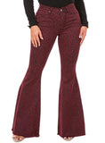 Woman wearing high-rise burgundy flared jeans with a leopard print pattern.