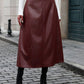 High-waisted burgundy midi skirt with crocodile texture details.