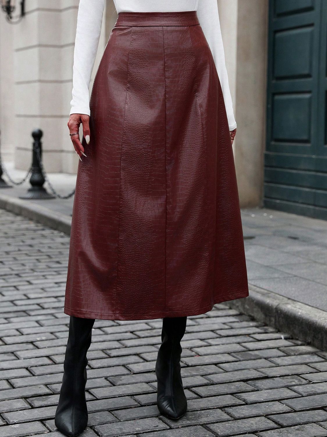 High-waisted burgundy midi skirt with crocodile texture details.