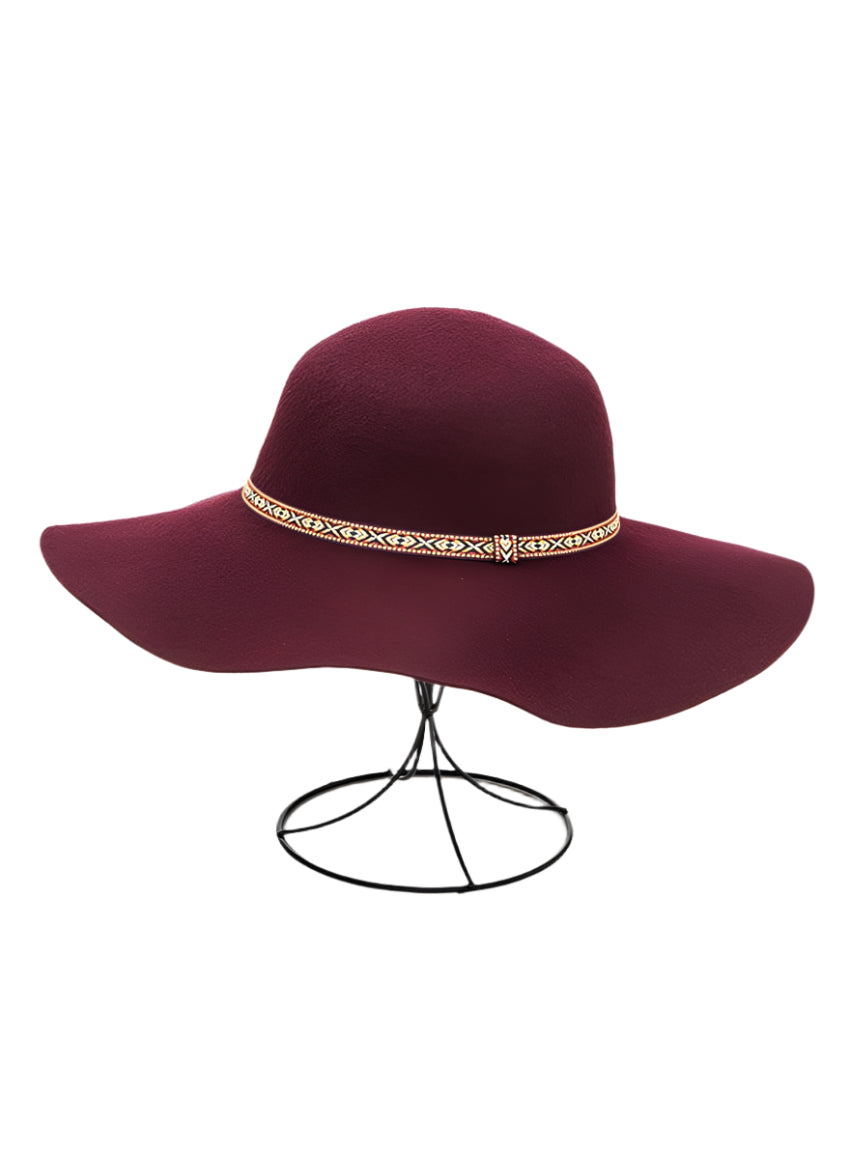 Front view of a burgundy wool felt floppy hat with a decorative band.
