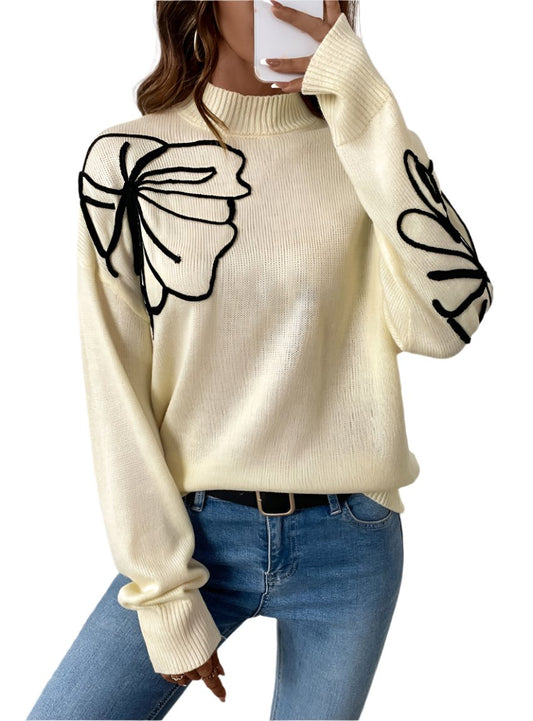 Butter yellow sweater with black floral line details on shoulders and sleeves, front view.
