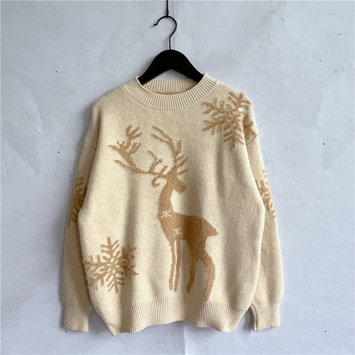 Front view of a butter yellow reindeer sweater with a fun and festive holiday design.

