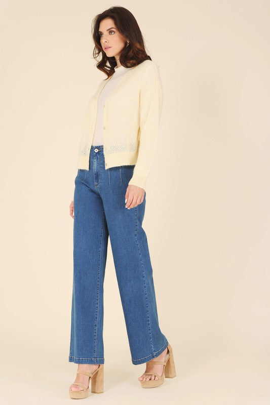 Butter yellow wool blended sheer cardigan styled with high-waisted jeans and a turtleneck