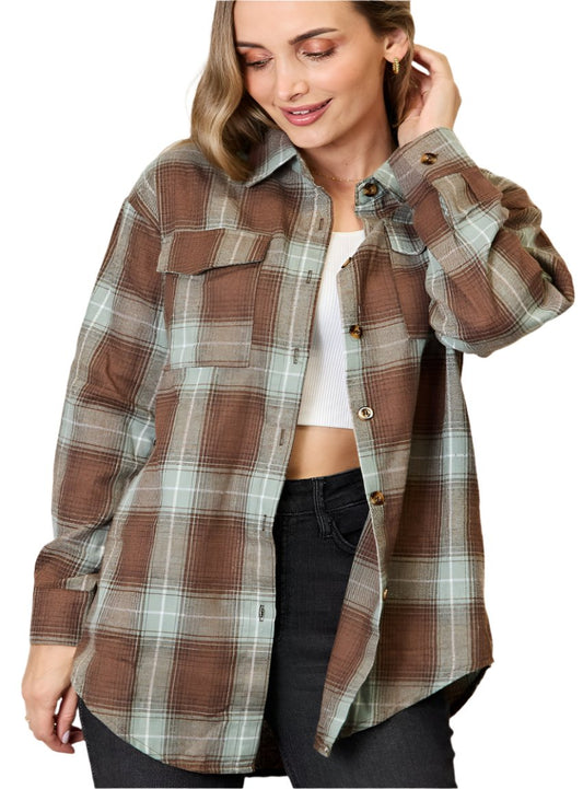 Model wearing a plaid flannel shirt in earthy tones, styled with black jeans.