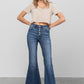 Button-down wide flare jeans by Insane Gene paired with sandals, highlighting the flared hem and casual style.