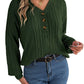 Woman wearing a green buttoned cable knit Henley sweater with blue jeans