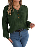 Woman wearing a green buttoned cable knit Henley sweater with blue jeans