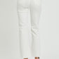 High-rise white jeans featuring knee rips and multiple button closure.