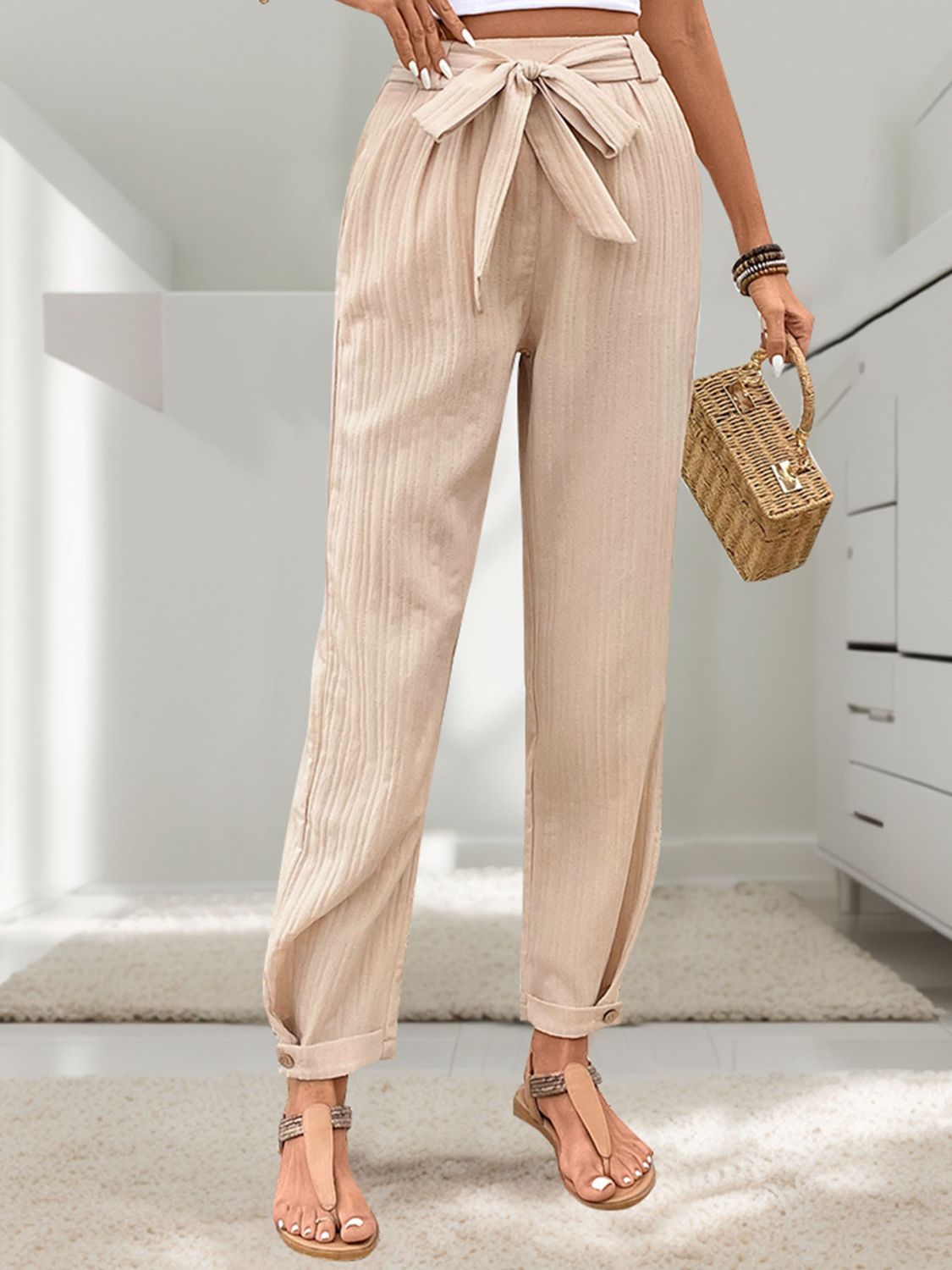 Bohemian-style beige drawstring pants made from soft, breathable fabric.