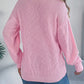 Casual pink cable knit cardigan with buttons for layering and comfort.
