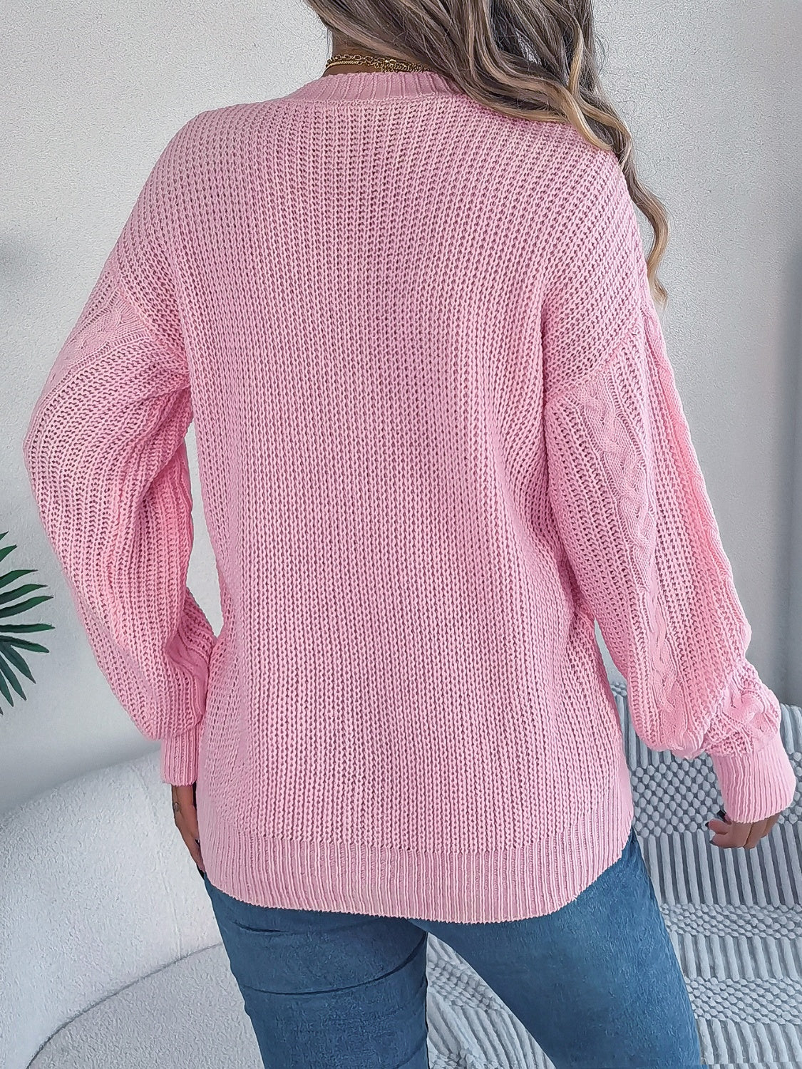 Casual pink cable knit cardigan with buttons for layering and comfort.
