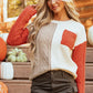 Cozy orange color block sweater featuring a front pocket and relaxed fit.
