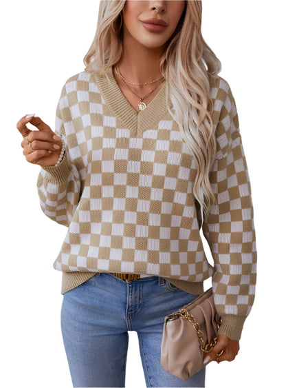 Woman wearing a camel checkerboard V-neck sweater with relaxed fit.
