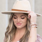 Front view of camel wide brim Panama hat with a sleek tassel accent.
