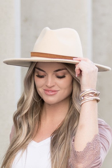 Front view of camel wide brim Panama hat with a sleek tassel accent.
