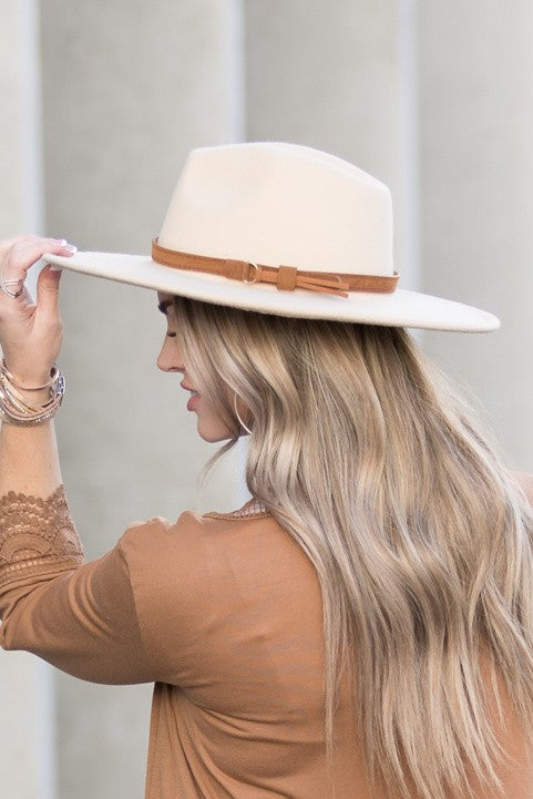 Camel wide brim Panama hat with a tassel belt shown from the side profile.
