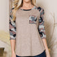 Tan top with camo print sleeves and pocket
