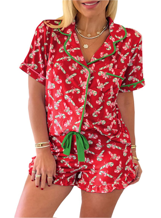 Front view of a festive candy cane pajama set with a button-up shirt and knotted shorts.
