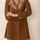 Soft caramel button-front dress with boho embroidery details
